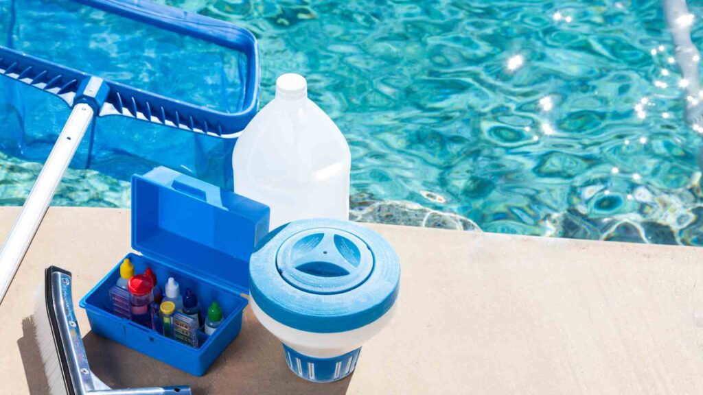 Pool maintenance supplies next to a clear blue swimming pool
